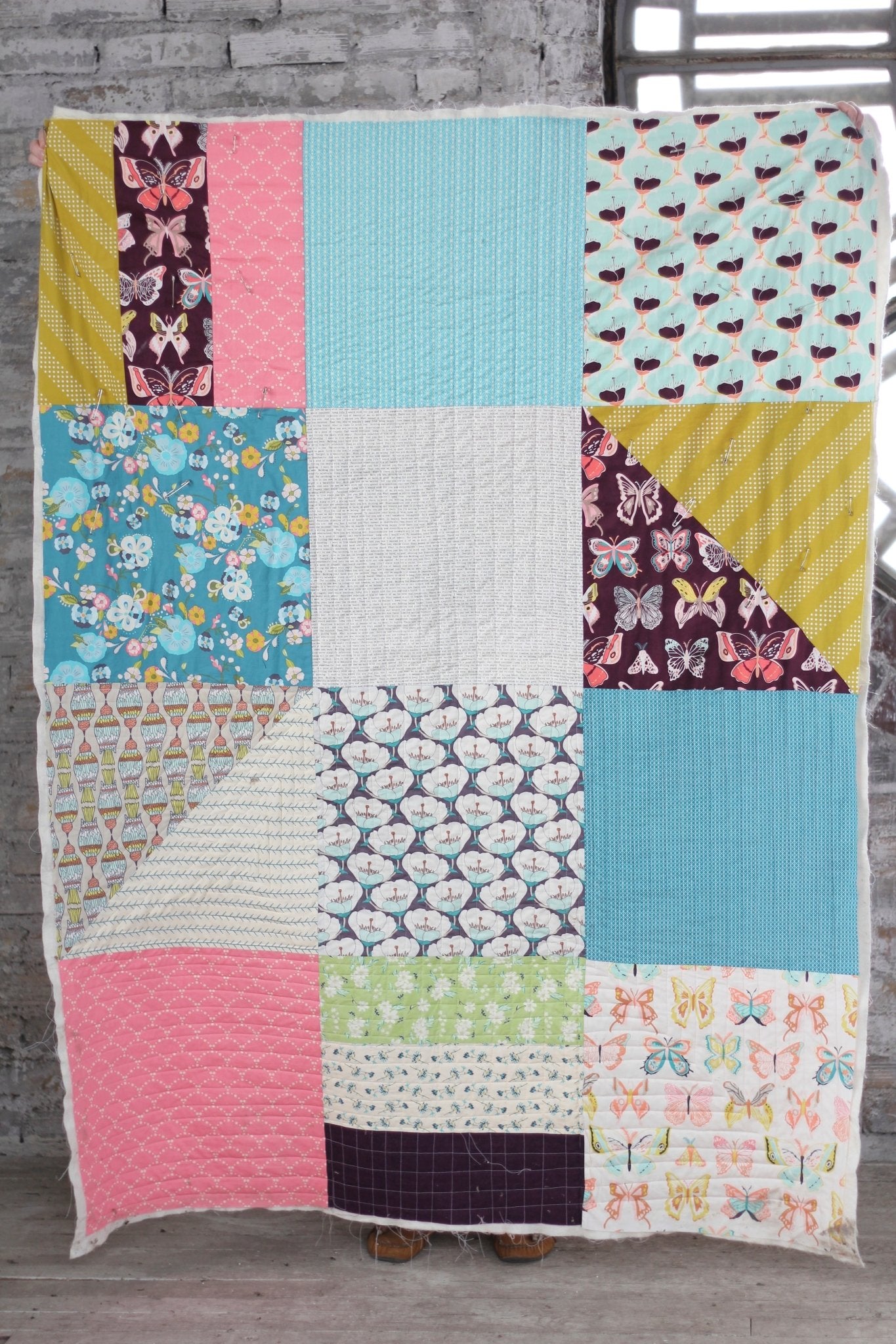 Finished quilting 101 quilt using a muted color-way with a variety of prints.