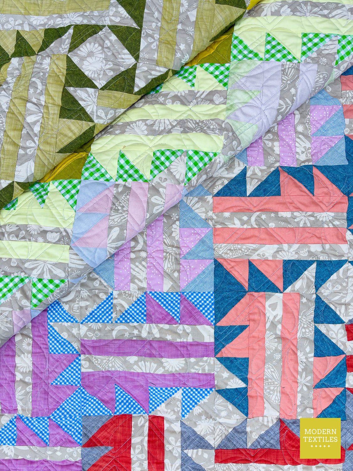 Finished ombre modern quilt stitched with an edge-to-edge digital pantograph using longarm quilting.