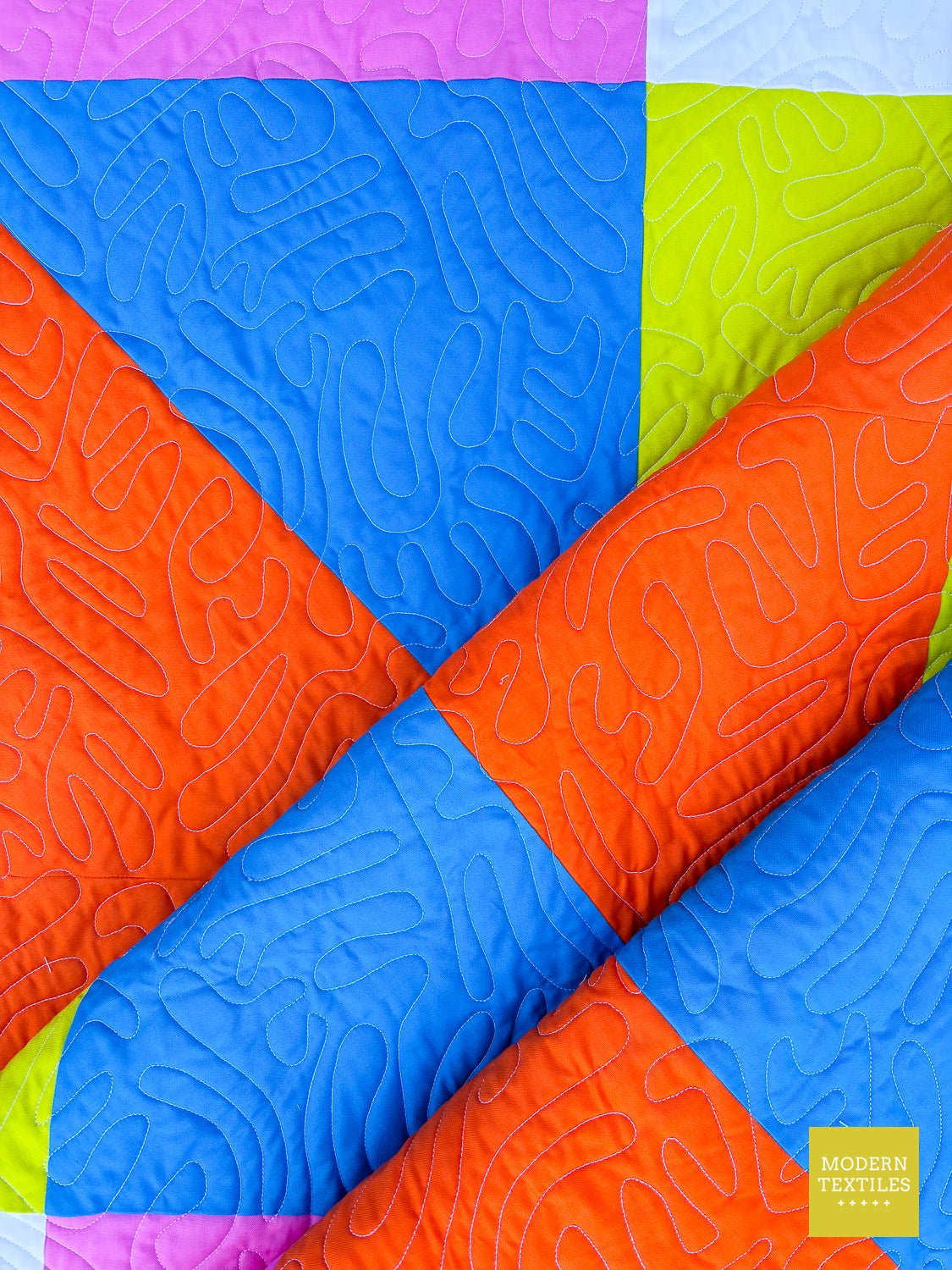 Close-up of Picnic quilt block seams and quilting stitches.