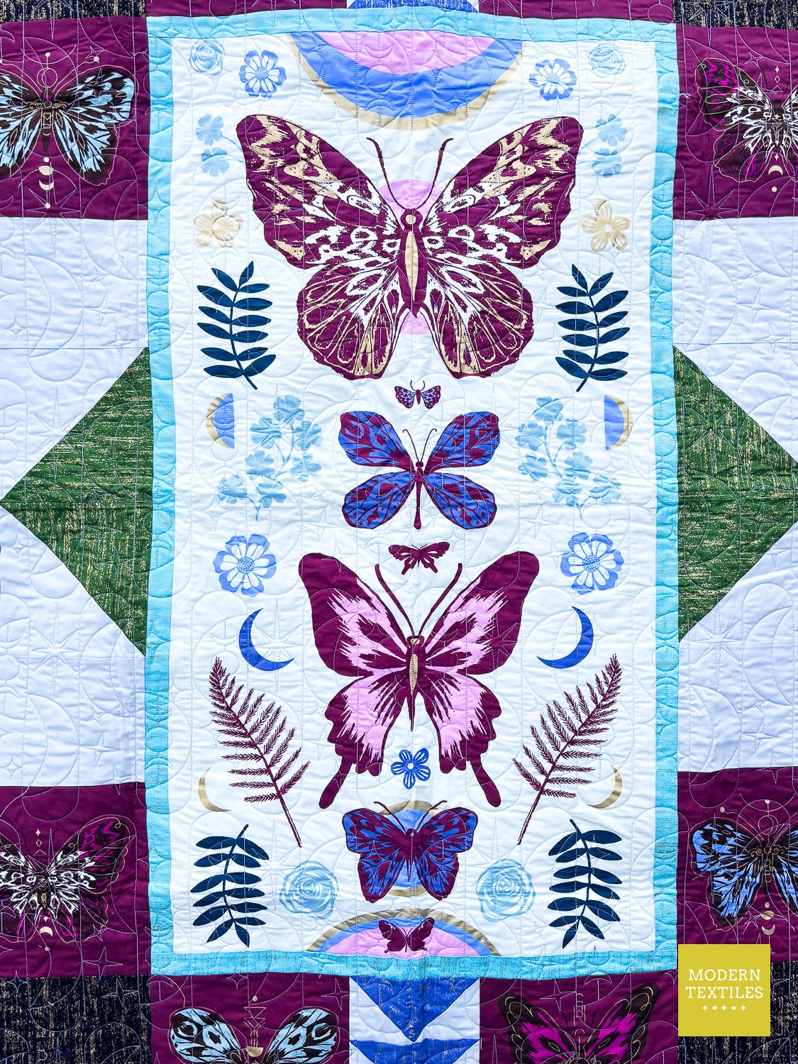 Full view of modern butterfly quilt longarm quilted with the Celestial Sky design.