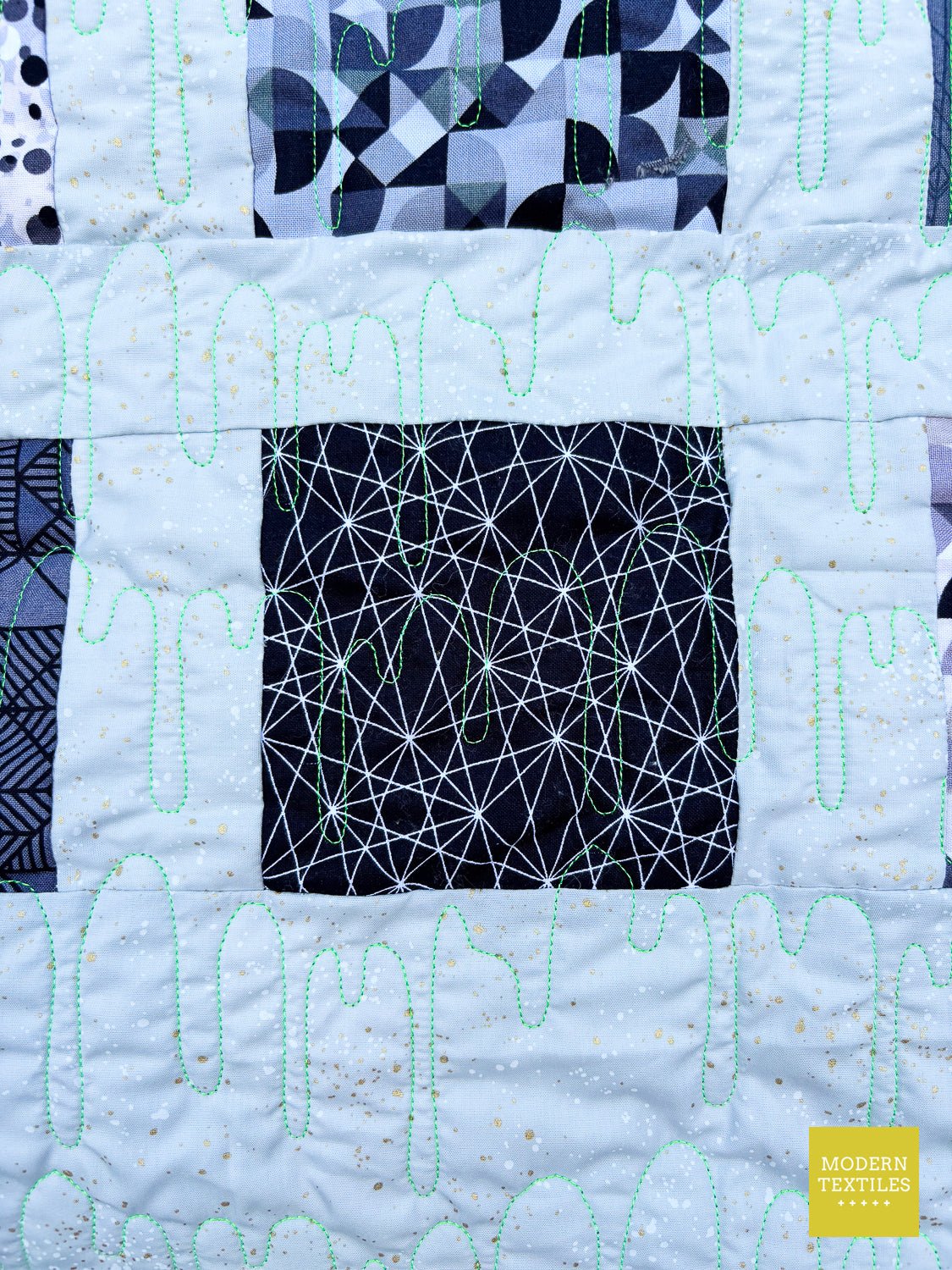 Single quilt block detail from Confetti charm pack quilt made with Libs Elliott Stealth fabrics.