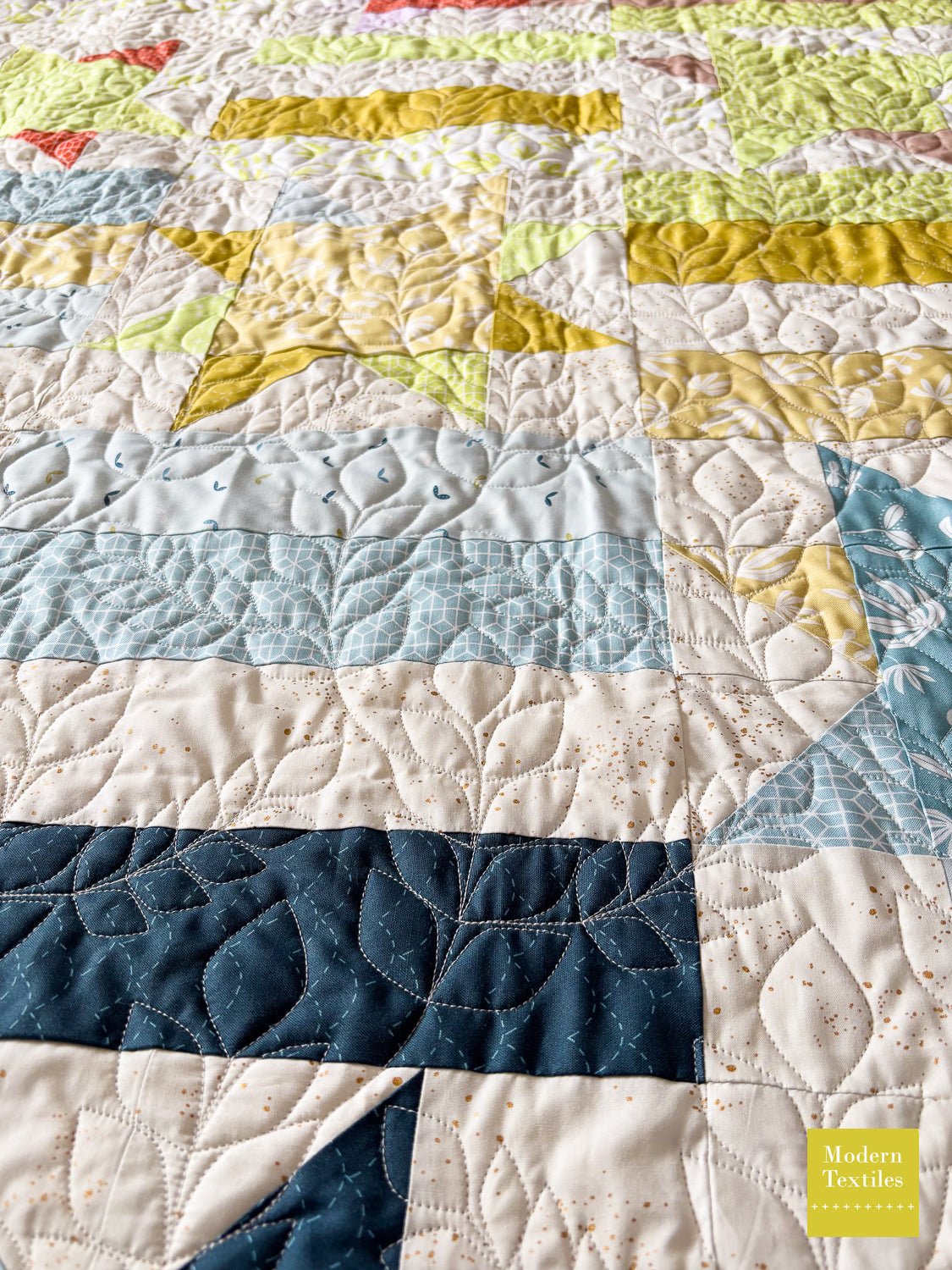 Finished quilt showing Climbing Vines edge-to-edge quilting design stitched evenly across the quilt top.