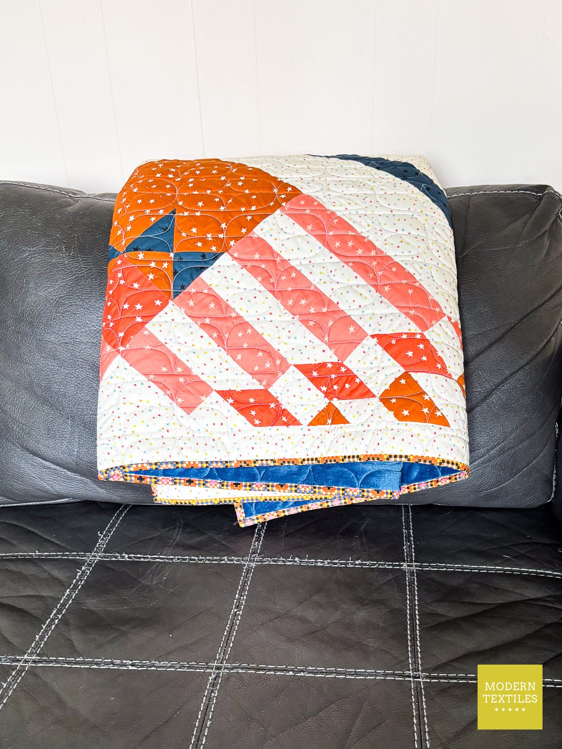 Folded Nebulous quilt featuring Oval Peel longarm quilting.