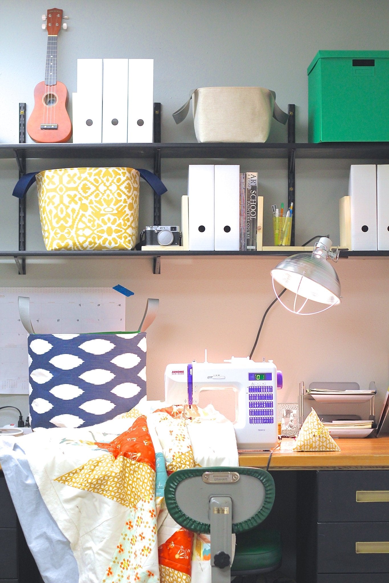 Bucket tote displayed in a sewing workspace, surrounded by tools and fabric for scale and context.