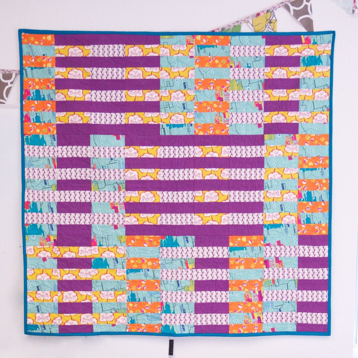 Colorful version of the Formation quilt pattern showing a patchwork layout in bright fabrics.
