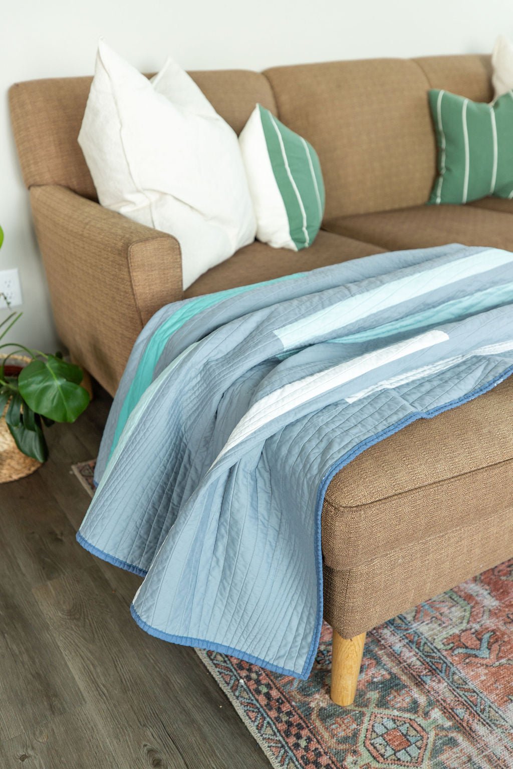 Horizon quilt draped over sofa styled as a modern throw blanket.