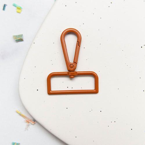 Carmel metal swivel hook snap hook on a speckled white surface