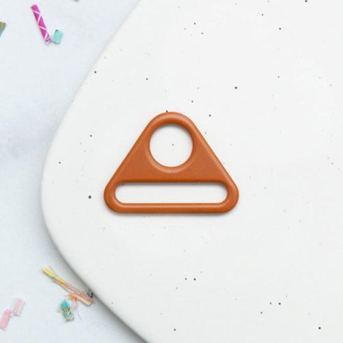Carmel triangular metal d-ring on a white speckled surface