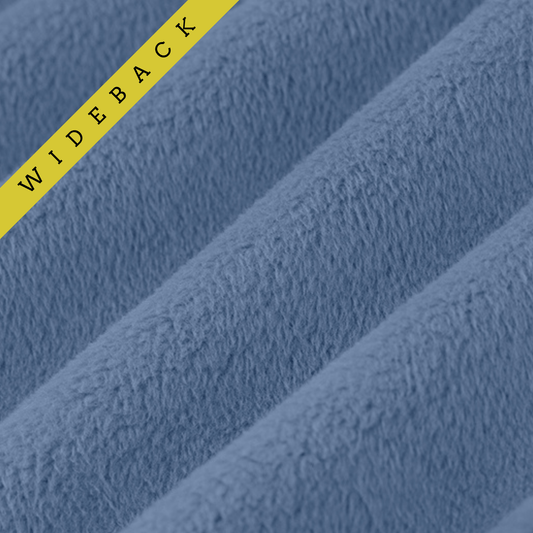 Soft minky in medium denim blue color, folded onto itself to show dimension. Text overlay of Wideback in corner.