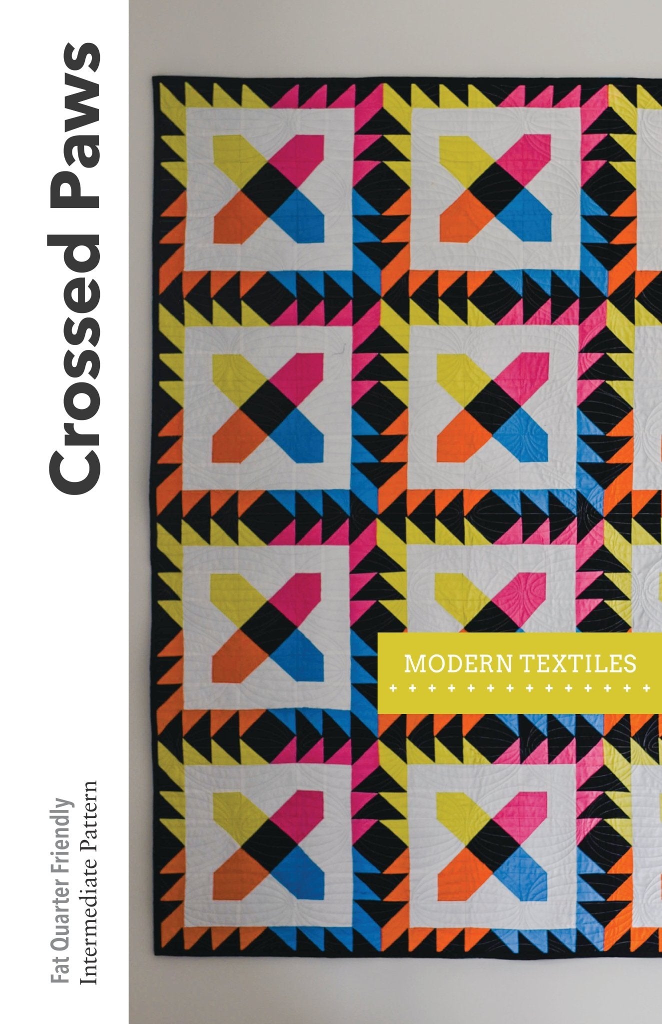 Cover of Crossed Paws pattern with half of the quilt shown and Modern Textiles logo overlayed on top of quilt.