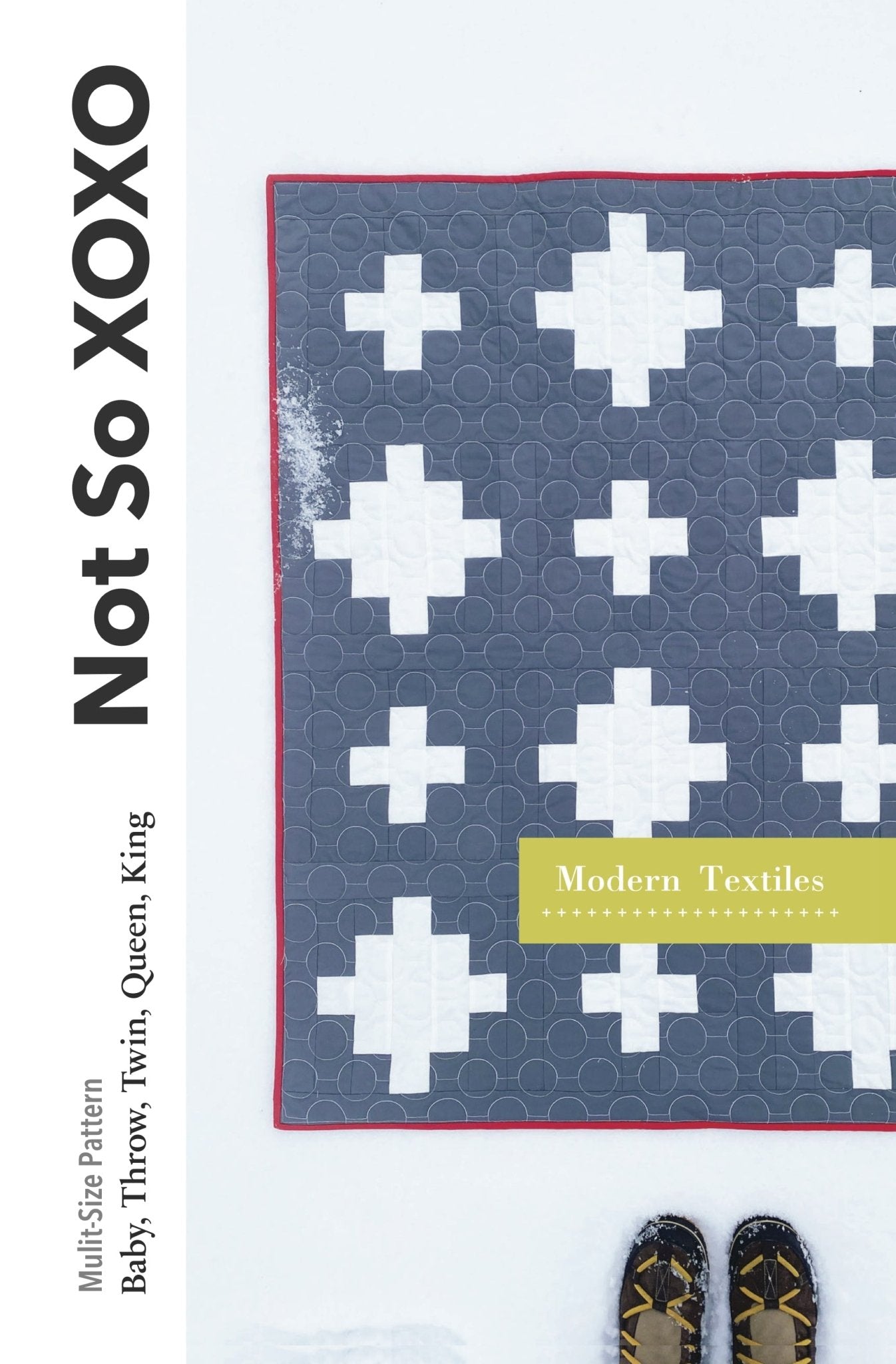 Modern Textiles Not So XOXO quilt pattern cover showing a gray and white modern Plus quilt photographed on winter snow.