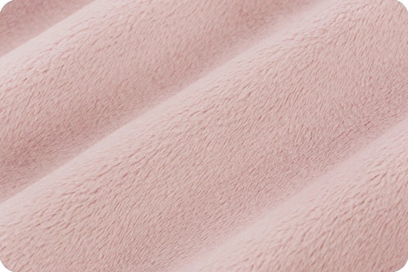 Closeup of light pinky soft fabric with a slight loft.