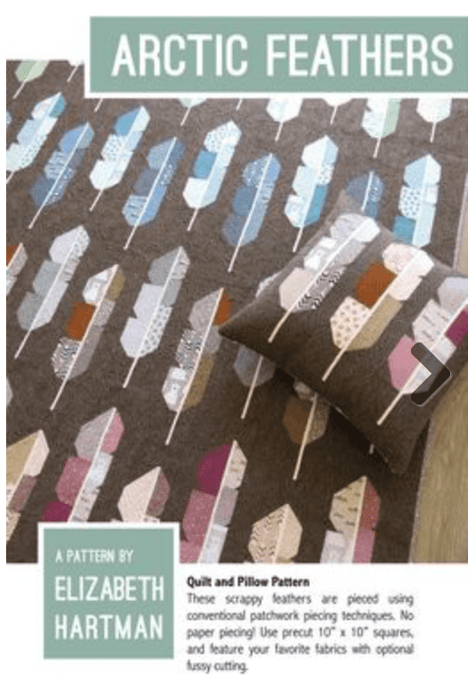 Artic Feathers quilt pattern cover showing brown quilt with teal, white and natural color feathers.